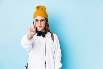 Wall Mural - Young caucasian woman with earphones isolated showing number one with finger.