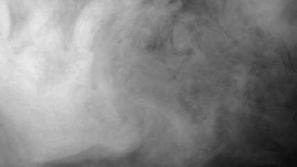 Wall Mural - White smoke on a black background. Start the cloud moving from the top to the bottom quickly. The concept of transitions for video editing using the alpha channel.