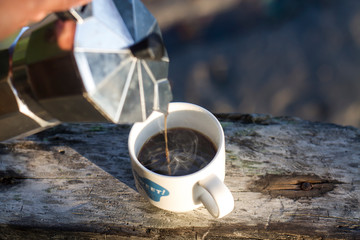 Wall Mural - Morning hot coffee with traditional coffee pots The background image is a sea view.