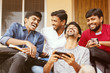 Group of happy young college students by looking at mobile phone laughing loudly at university campus - Millennials enjoying online video content or social media by watching smart phone.