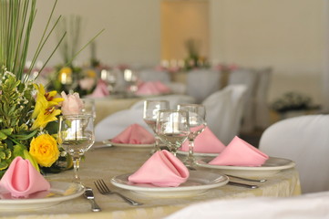 Table setting with glasses, plates, napkins and food