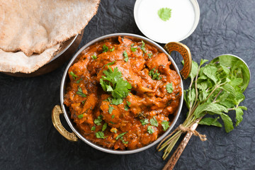 Poster - butter chicken, murgh makhani curry hot and spicy gravy dish on dark black background in punjab, hyd