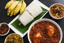 Rice Puttu Or Steamed Rice Cake With Egg Roast Curry,  Yellow Banana, Green Gram And Chickpea Curry Popular Kerala Breakfast Food, India. 