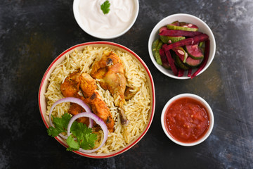 Wall Mural - Chicken or Mutton Biryani, Pulao spicy mixed rice dish with meat curry, almonds during Ramadan festival Hyderabad, India.