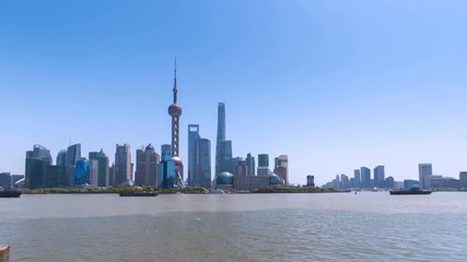 Fototapete - time lapse of shanghai skyline in sunny afternoon by huangpu riverside, China