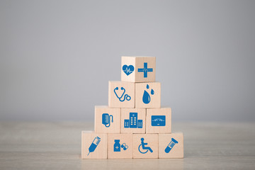 Health Insurance Concept,arranging wood block stacking with icon healthcare medical.