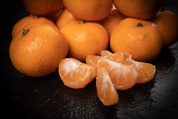 Wall Mural - Mandarines, tangerine, clementine on black background