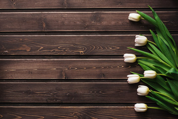 Wall Mural - White tulips on a brown wooden table. Blank greeting card for Valentine's day