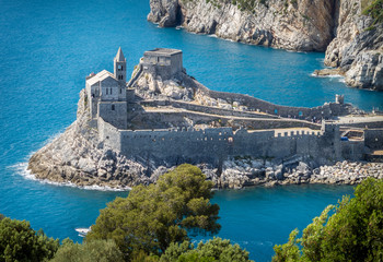 Porto Venere (Portovenere), Liguria, Italy: beautiful aerial scenic view of the Church of St. Peter (Chiesa di San Pietro) from Palmaria Island nearby Cinque Terre with Byron grotto