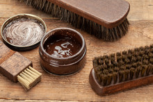 Brush For Shoes. Cleaning And Polishing Shoes With Brushes. Shoe Polish And Brush On Wooden Background