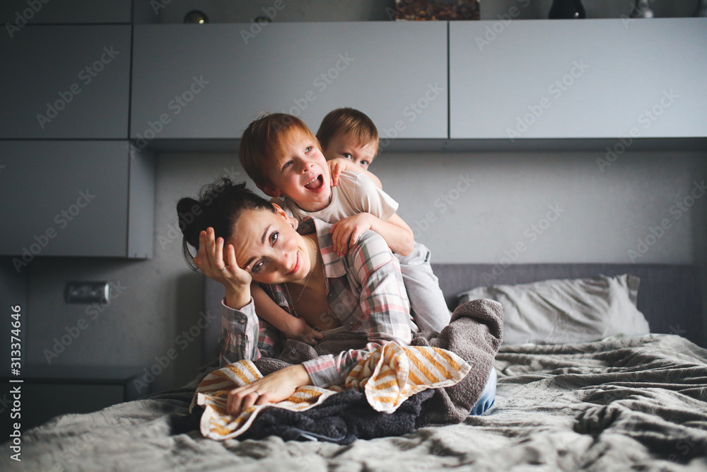 tired mother with two children,Authentic lifestyle - obrazy, fototapety, plakaty 