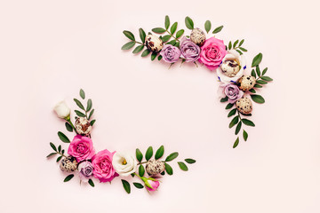 Wall Mural - Creative Floral Easter Frame of roses, green leaves and quail eggs on pink paper background