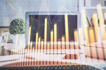 Stock market chart hologram drawn on personal computer background. Multi exposure. Concept of investment.