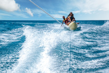 A Group Of People Enjoing The Banana Riding. Water Sport Concept 