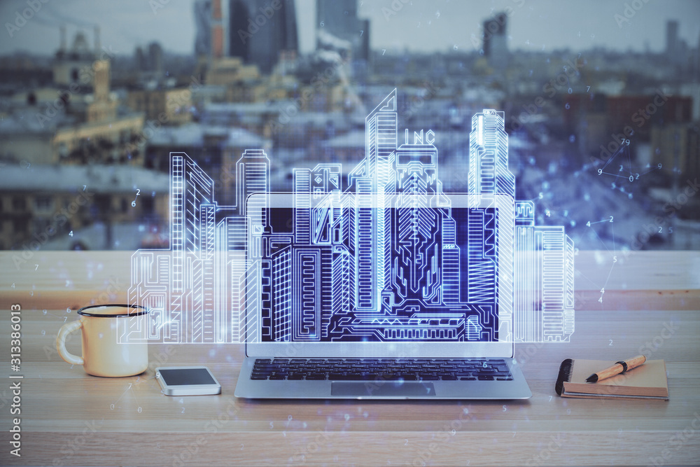 Desktop computer background in office and big town buildings hologram drawing. Double exposure. Smart city concept. - obrazy, fototapety, plakaty 