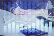 © peshkova - Double exposure of man doing analysis of stock market with forex graph.
