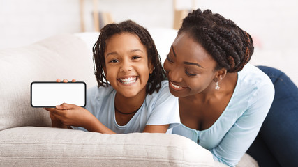 Black family showing blank phone screen for ad
