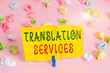 Handwriting text writing Translation Services. Conceptual photo organization that provide showing to translate speech Colored crumpled papers empty reminder pink floor background clothespin
