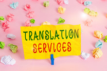 Handwriting Text Writing Translation Services. Conceptual Photo Organization That Provide Showing To Translate Speech Colored Crumpled Papers Empty Reminder Pink Floor Background Clothespin