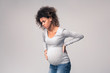 Pregnant woman suffering from abdominal and back pain