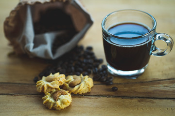 cup coffee, cookie on wooden table.