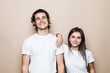 © F8  \ Suport Ukraine - Portrait of a smiling young couple hugging standing together over beige background