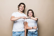 © F8  \ Suport Ukraine - Young couple give five on beige background