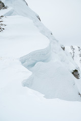  Detail of snow cornice forming on mountain ridge.