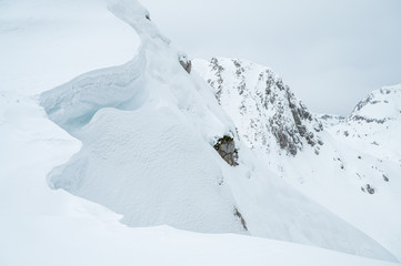  Detail of snow cornice forming on mountain ridge.