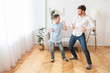 © Prostock-studio - Father And Son Dancing Having Fun At Home On Weekend
