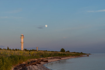 Wall Mural - Skew lighthouse in the Baltic Sea. Shore, evening light, sunset, moon and architecture concept. Harilaid, small island in Estonia, Europe.