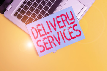 Text sign showing Delivery Services. Business photo showcasing the transport of items between two or more parties Part view trendy metallic laptop clipboard paper sheet colored background