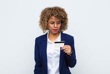 Young African American Woman Feeling Sad, Upset Or Angry And Looking To The Side With A Negative Attitude, Frowning In Disagreement With A Credit Card