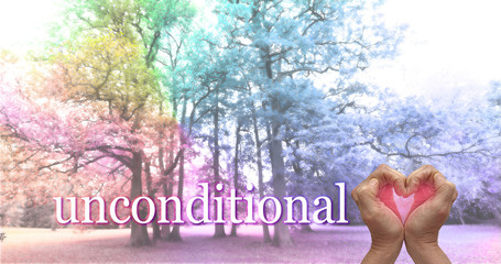 Wall Mural - Love Nature unconditionally concept - hands shaped into a heart with a pink light inside against a rainbow coloured copse of tall trees with a the word UNCONDITIONAL beside the love heart hands