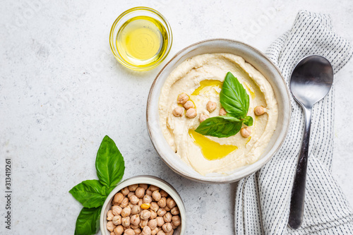 Fotomural Bowl of healthy homemade creamy chickpea hummus dip with olive oil, top view