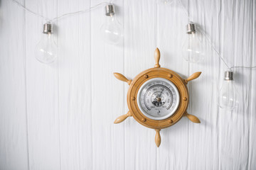Sea barometer on a white wooden background