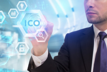 Business, Technology, Internet and network concept. Young businessman working on a virtual screen of the future and sees the inscription: ICO