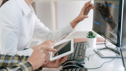 Young startup Programmers Sitting At Desks Working On Computers screen for Developing programming and coding to find solution to problem on New Application