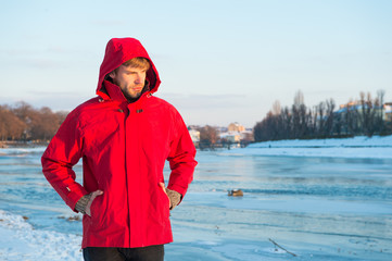 Pleasant thoughts. weather forecast. human and nature. man walking snowy landscape in sunset. travel and expedition concept. man in red parka. winter male fashion. warm clothes for cold climate