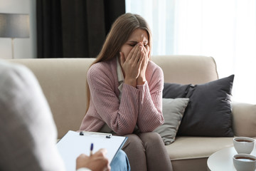 Canvas Print - Professional psychotherapist working with patient in office