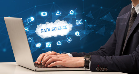 businessman working on laptop with data science inscription, modern technology concept