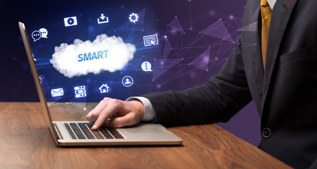 businessman working on laptop with smart inscription, modern technology concept