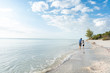 © Sarah Rypma - Father and son walking on a beach