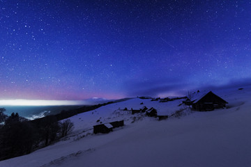 Wall Mural - fairytale landscapes of the winter carpathian mountains with a charming milky way in the sky tourist