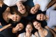 © fizkes - Top view smiling diverse people lying in circle on mats