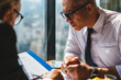 © Shutter B - Corporate business team meeting discussion and startup concept. Successful businesspeople discussing together in conference room during meeting at modern business lounge high up in an office tower.