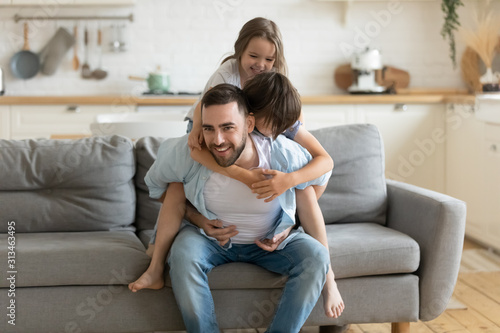 Fotomural Father playing enjoy active games with little children at home