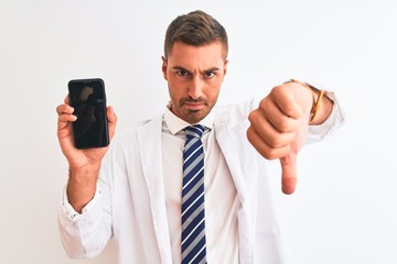 Canvas Print - Young scientist man showing smartphone screen over isolated background with angry face, negative sign showing dislike with thumbs down, rejection concept