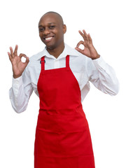 Wall Mural - Laughing african american waiter with red apron