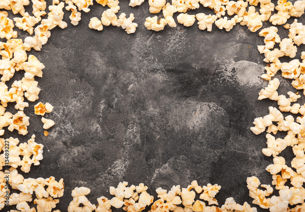 Frame made of tasty popcorn on dark background